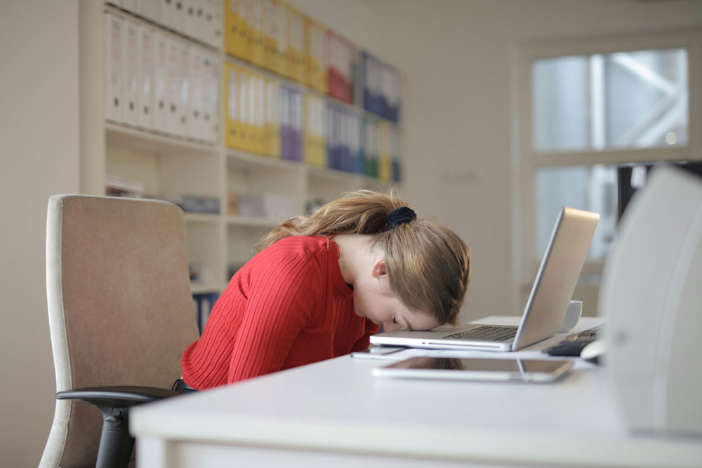 woman sleeping at laptop