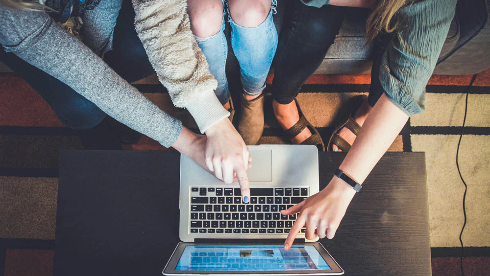 girls looking at laptop