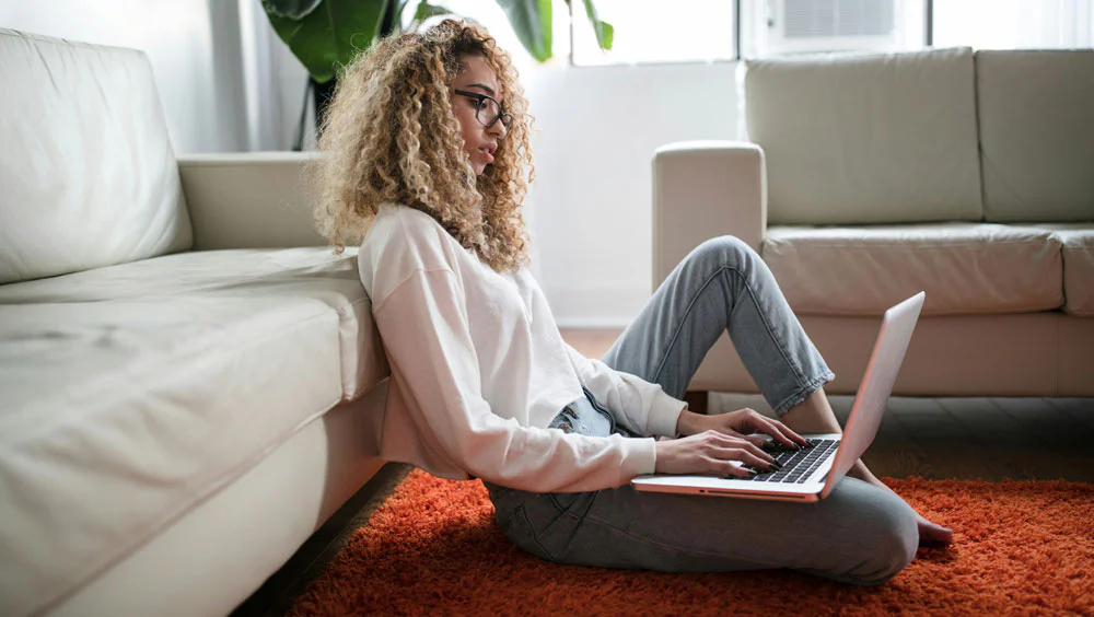 Woman sitting on floor with laptop